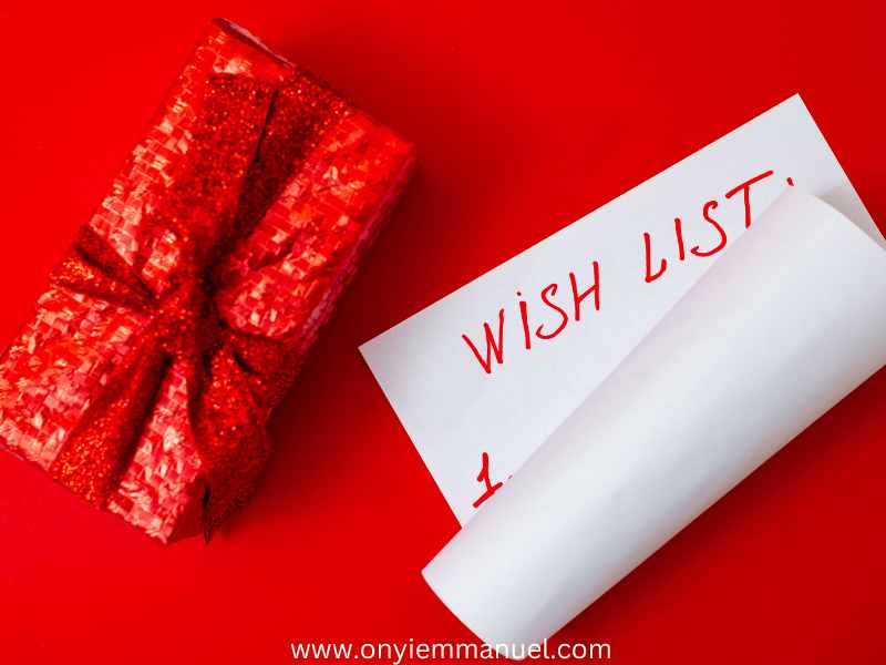 A-half-folded-white-paper-beside-a-red-gift-box-on-a-red-background-as-23-best-christmas-wishlist-ideas-you-will-love-in-2024