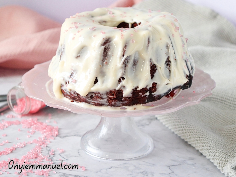 Fluffy moist red velvet bundt cake drizzled with cream cheese frosting